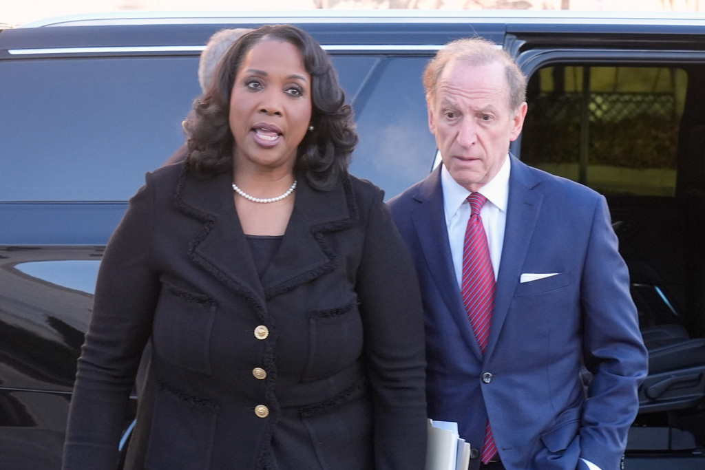 Federal Reserve governor Lisa Cook and attorney Abbe Lowell, arrive at the Supreme Court in Washington, Wednesday, Jan. 21, 2026. (AP Photo/Mark Schiefelbein)