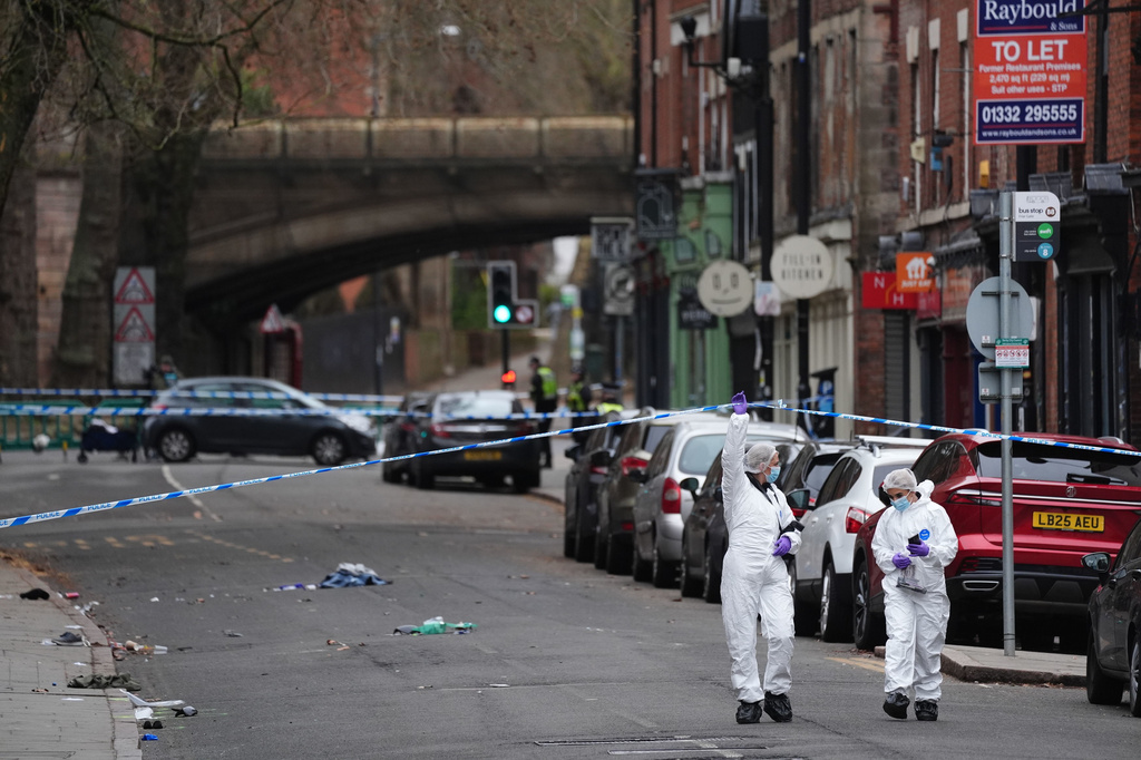Forensic investigators work on the scene in Friar Gate, Derby, Sunday March 29, 2026, where a number of people had been injured, some of them seriously, after being hit by a car in the city centre on Saturday night. (Jacob King/PA via AP)