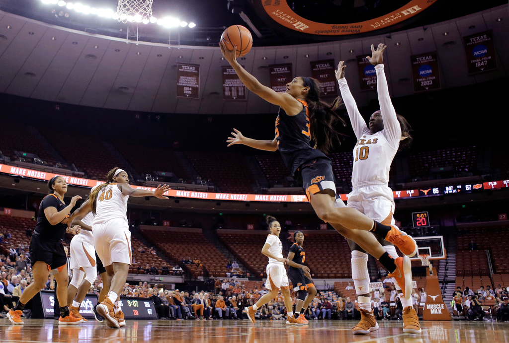 FILE - Oklahoma State guard Loryn Goodwin (32) drives around Texas guard Lashann Higgs (10) during the second half of an NCAA college basketball game Jan. 3, 2018, in Austin, Texas. (AP Photo/Eric Gay, File)