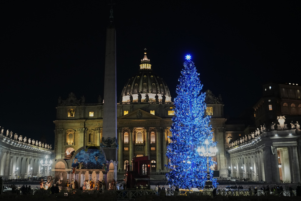 A 27-meter fir tree from the Ultimo valley in South Tyrol, Italy, is lit up as Christmas tree together with a crib in St. Peter's Square at the Vatican, Monday, Dec. 15, 2025. (AP Photo/Alessandra Tarantino)