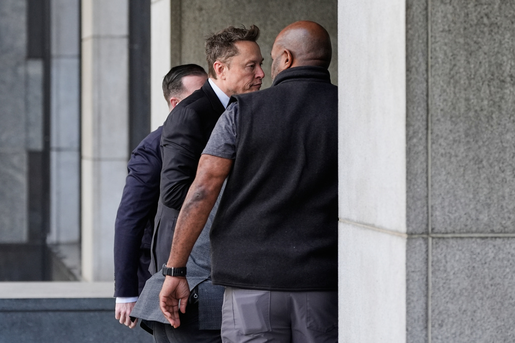 Elon Musk, center, arrives for a Twitter shareholder trial at the U.S. District Court for the Northern District of California in San Francisco, on Wednesday, March 4, 2026. (AP Photo/Godofredo A. Vásquez)