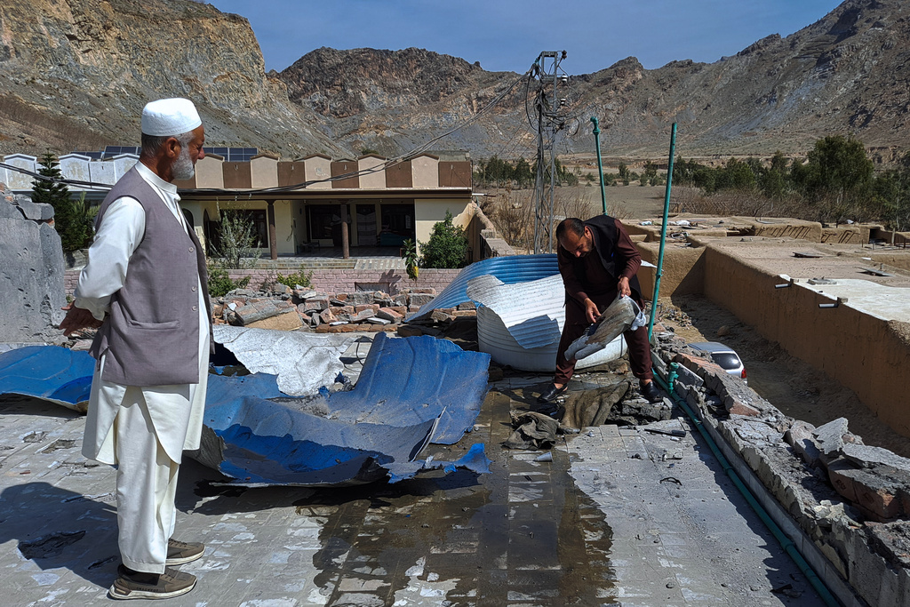 Local residents examine damages to their house due to mortar shell fired by Afghan forces, at a village in Khyber, a district of Pakistan's Khyber Pakhtunkhwa province bordering with Afghanistan, Thursday, March 5, 2026. (AP Photo/S.B. Shah)