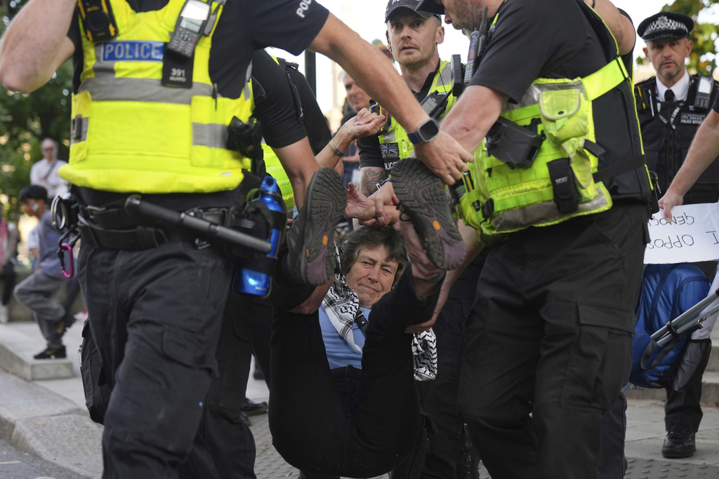 Police officers carry a protester during a protest to support Palestine Action in London, Saturday, Sept. 6, 2025.(AP Photo/Joanna Chan)