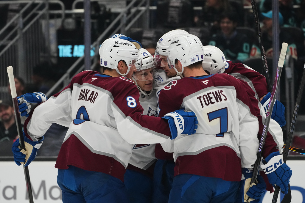 Colorado Avalanche center Martin Necas, third from left, celebrates his goal against the Seattle Kraken with teammates, including defenseman Cale Makar (8), center Nathan MacKinnon (29) and defenseman Devon Toews (7) during the first period of an NHL hockey game Thursday, March 12, 2026, in Seattle. (AP Photo/Lindsey Wasson)