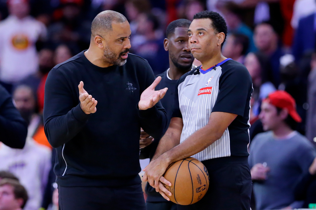 Houston Rockets head coach Ime Udoka, left, appeals to official Kari Lane, right, as a possible flagrant foul call against Jabari Smith Jr. is reviewed in the last 14 seconds of the second half of an NBA basketball game against the LA Clippers Thursday, Dec. 11, 2025, in Houston. (AP Photo/Michael Wyke)