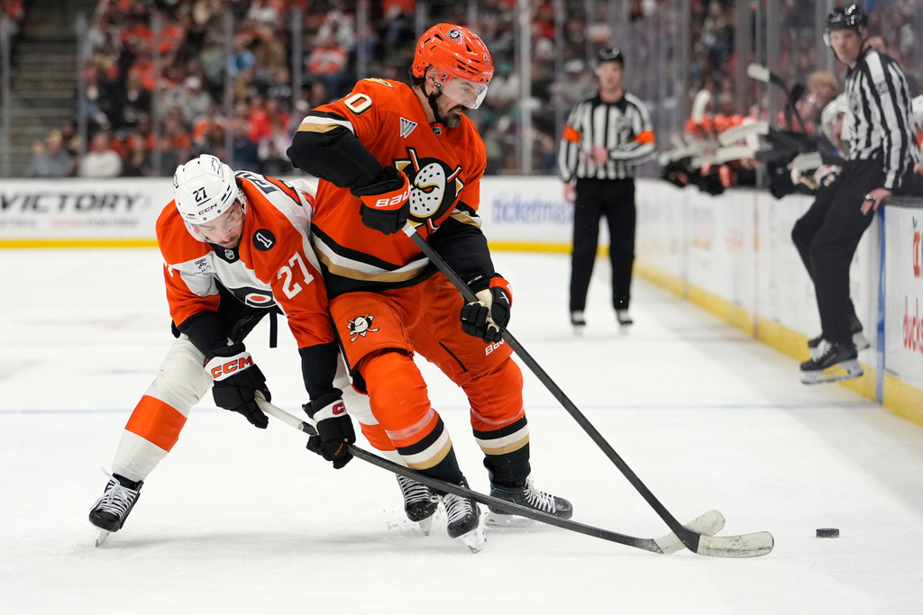 Philadelphia Flyers left wing Noah Cates, left, reaches in on Anaheim Ducks left wing Chris Kreider during the first period of an NHL hockey game Wednesday, March 18, 2026, in Anaheim, Calif. (AP Photo/Mark J. Terrill)