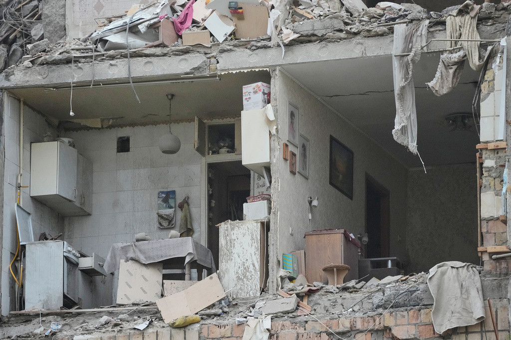 The damaged apartment interior in the ruined apartment building following Russia's missile attack in Kyiv, Ukraine, Monday, July 6, 2026. (AP Photo/Efrem Lukatsky)