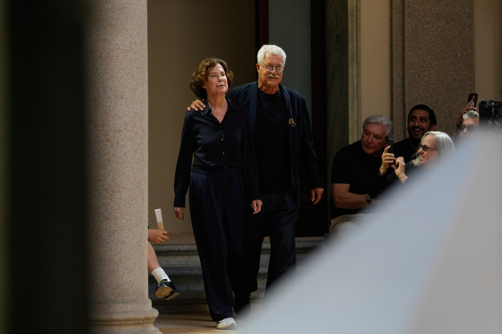 Fashion designers Leo Dell'Orco, right, and Silvana Armani arrive on the catwalk at the end of the Giorgio Armani Spring/Summer 2027 men's collection presented in Milan, Italy, Monday, June 22, 2026. (AP Photo/Luca Bruno)