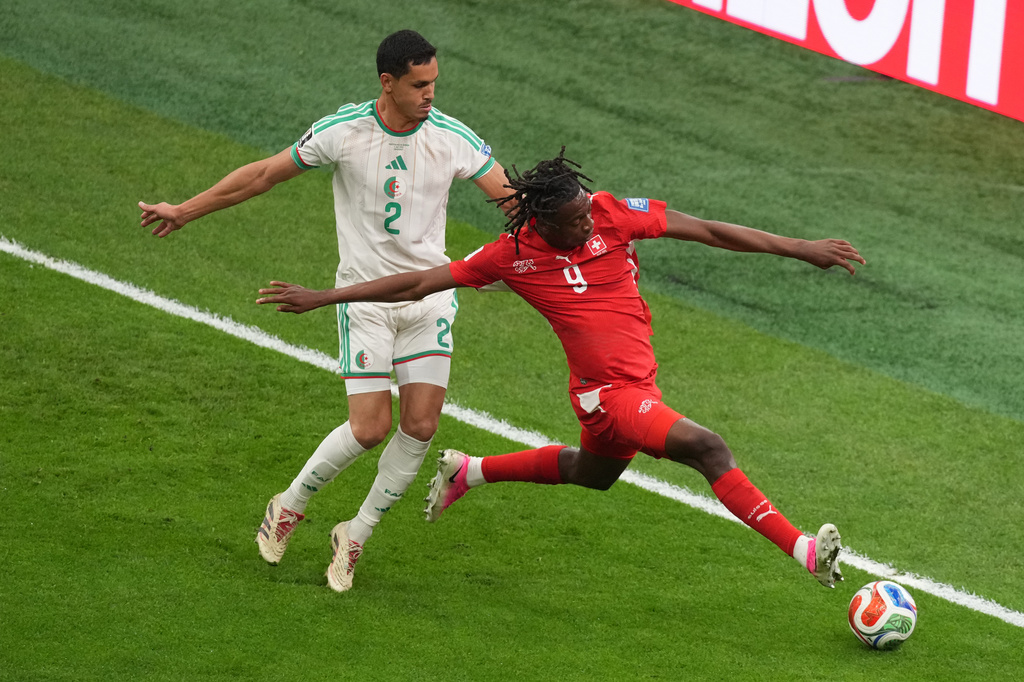 Switzerland's Johan Manzambi (9) battles with Algeria's Aissa Mandi (2) during the World Cup round of 32 soccer match between Switzerland and Algeria in Vancouver, British Columbia, Thursday, July 2, 2026. (AP Photo/Nick Didlick)