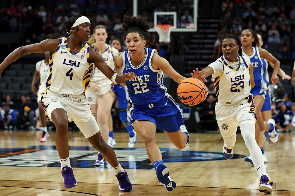 Duke guard Taina Mair (22) drives to the basket with LSU guards Flau'jae Johnson (4) and MiLaysia Fulwiley (23) defending during the first half in the Sweet 16 of the NCAA college basketball tournament Friday, March 27, 2026, in Sacramento, Calif. (AP Photo/Sara Nevis)
