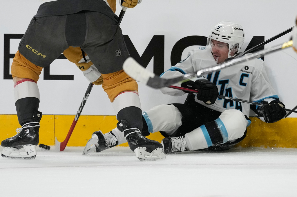 Utah Mammoth right wing Clayton Keller (9) fights for the puck against the Vegas Golden Knights during the first period in Game 1 of a first-round NHL hockey Stanley Cup playoff series Sunday, April 19, 2026, in Las Vegas. (AP Photo/John Locher)
