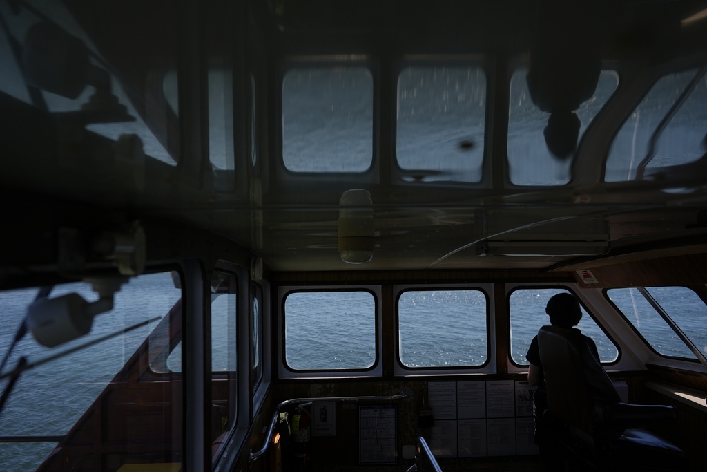 Expedition 501 member Verena Heuer looks out from the bridge of the Gaspee, a crew transport vessel, as it travels along Sakonnet River near Portsmouth, R.I., during the eight-hour trip to the Liftboat Robert platform in the North Atlantic, Saturday, July 19, 2025. (AP Photo/Carolyn Kaster)
