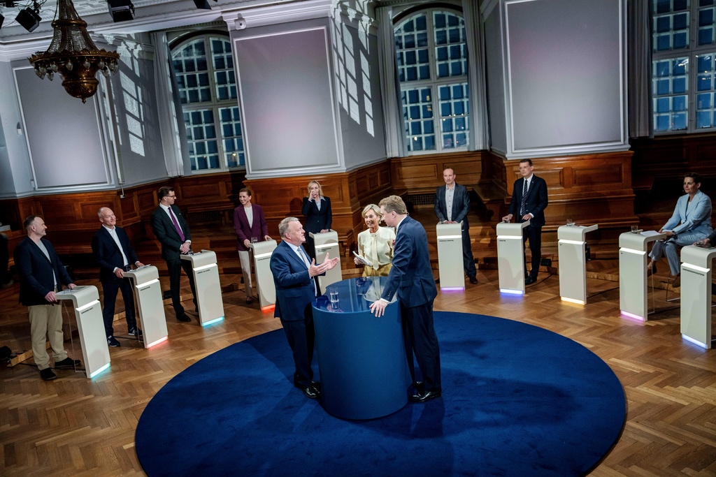 Leader of the Moderates Lars Loekke Rasmussen, center left, and leader of the Danish People's Party Morten Messerschmidt , center, right, speak during TV2's party leader debate 'The Last Answer' in the Common Hall at Christiansborg, in Copenhagen, Monday, March 23, 2026. (Mads Claus Rasmussen/Ritzau Scanpix via AP)