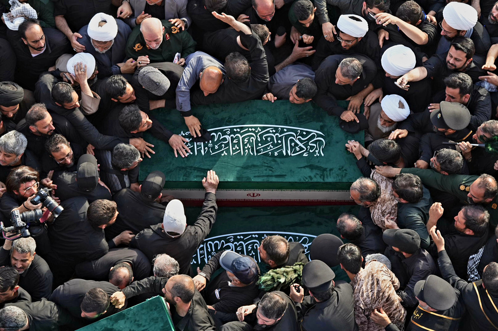 In this photo released by Iran's Supreme Leader's office, mourners carry the coffins of the late Iranian Supreme Leader Ayatollah Ali Khamenei and members of his family during funeral prayers held as part of the dayslong funeral ceremonies at the Holy Jamkaran Mosque in Qom, Iran, Tuesday, July 7, 2026. (Office of the Iranian Supreme Leader via AP)