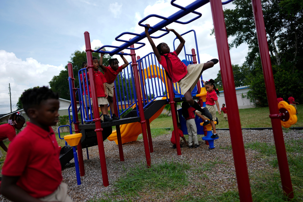 FILE - Students from Thomas Leadership Academy play on the school's playground in Eatonville, Fla., on Aug. 23, 2023. (AP Photo/Rebecca Blackwell, File)