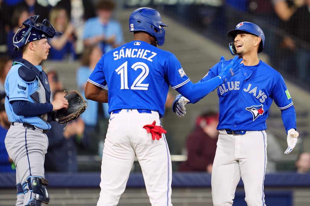 Toronto Blue Jays' Andres Gimenez, right, celebrates after his three-run home run with teammate Jesus Sanchez (12) during second-inning baseball game action against the Tampa Bay Rays in Toronto, Monday, May 11, 2026. (Frank Gunn/The Canadian Press via AP)