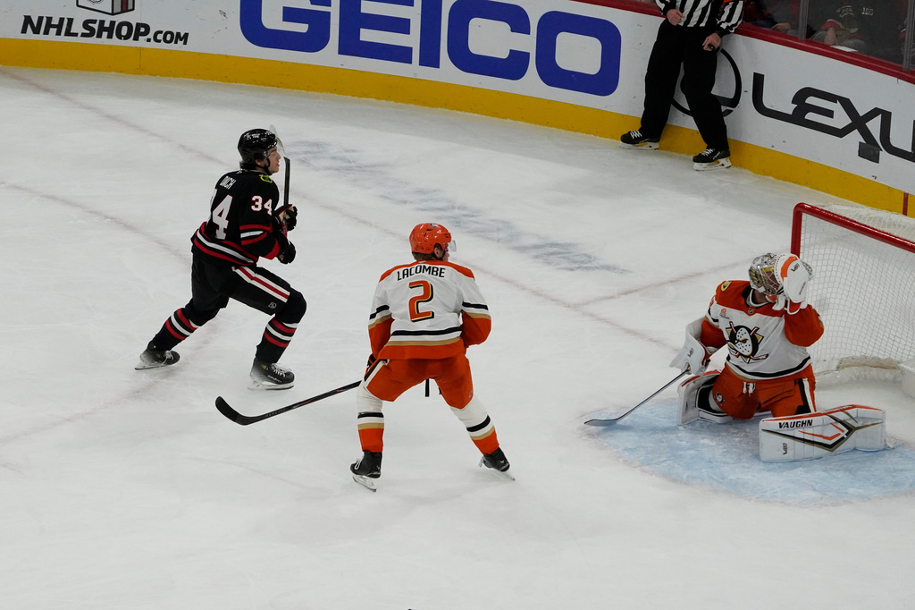 Chicago Blackhawks center Colton Dach, left, scores a goal on Anaheim Ducks goaltender Petr Mrazek, right, during the second period of an NHL hockey game, Sunday, Nov. 30, 2023, in Chicago. (AP Photo/David Banks)