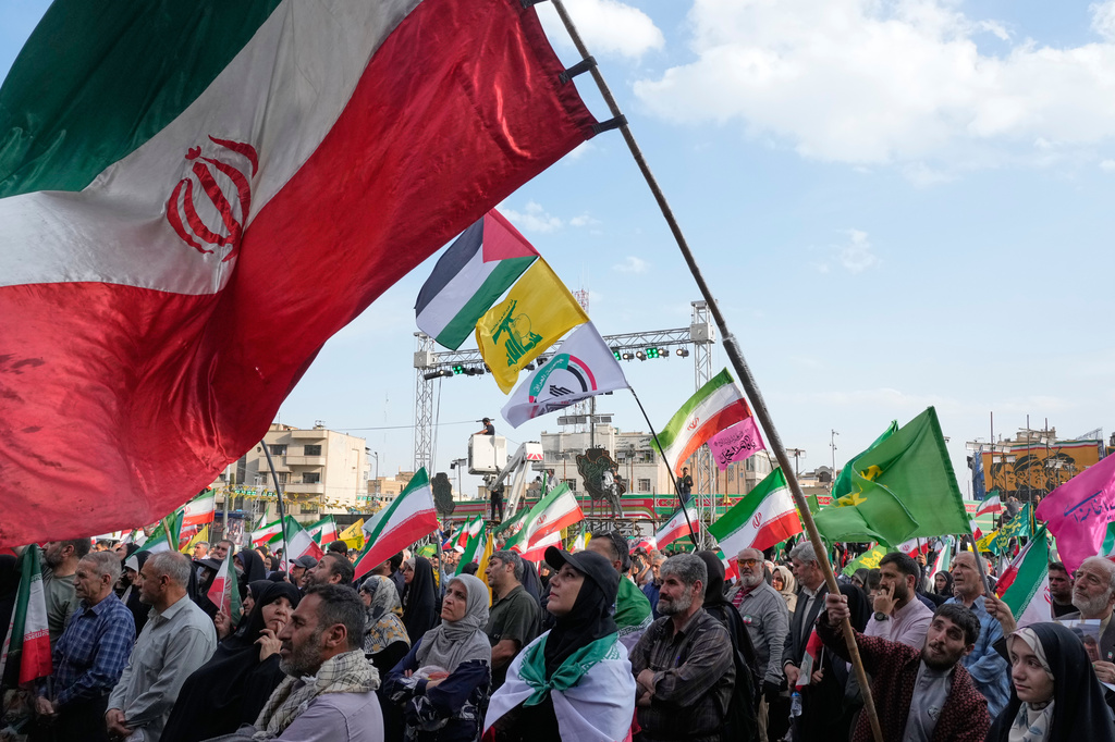 A man waves a representation of the Iranian flag during a state-organised rally in Tehran, Iran, Wednesday, April 29, 2026, celebrating the birthday of Imam Reza, the 8th Shiite Muslims' Imam, and showing their support to the Iranian Supreme Leader Ayatollah Mojtaba Khamenei. (AP Photo/Vahid Salemi)