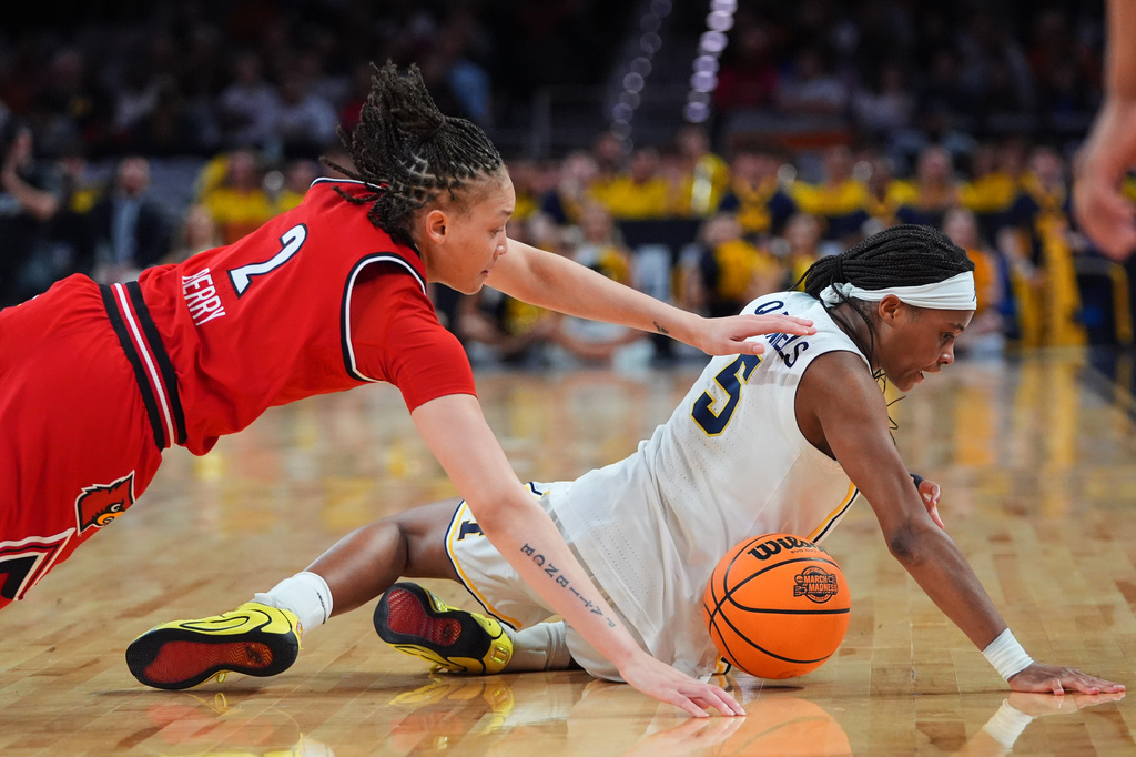 Louisville guard Imari Berry (2) and Michigan guard Brooke Q. Daniels (5) dive to the floor competing for control of a loose ball in the first half in the Sweet 16 of the NCAA college basketball tournament, Saturday, March 28, 2026, in Fort Worth, Texas. (AP Photo/LM Otero)