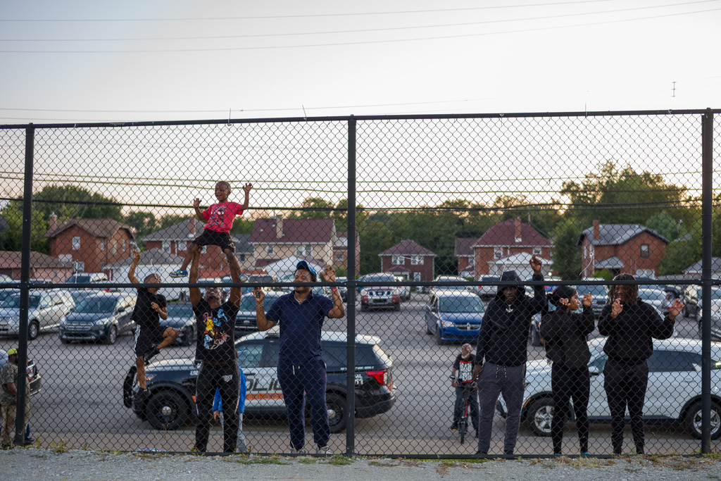 People watch the first high school football game of the season from behind a fence at Clairton's football stadium in Clairton, Pa., on Friday, Aug. 22, 2025. (Quinn Glabicki/Pittsburgh's Public Source via AP)