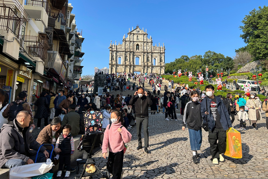 FILE - Travelers from mainland China gather near the Ruins of St. Paul's, a tourist destination in Macao, Jan. 18, 2022. (AP Photo/Kanis Leung, File)