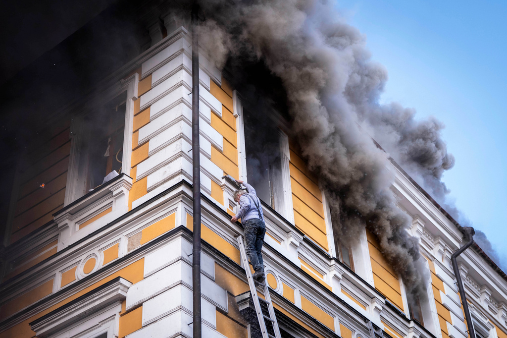 A man evacuates a burning building using a rescue ladder from the National Academy of Sciences building damaged after a Russian drone strike in the center of Kyiv, Ukraine, Monday, Sept. 28, 2026. (AP Photo/Dan Bashakov)