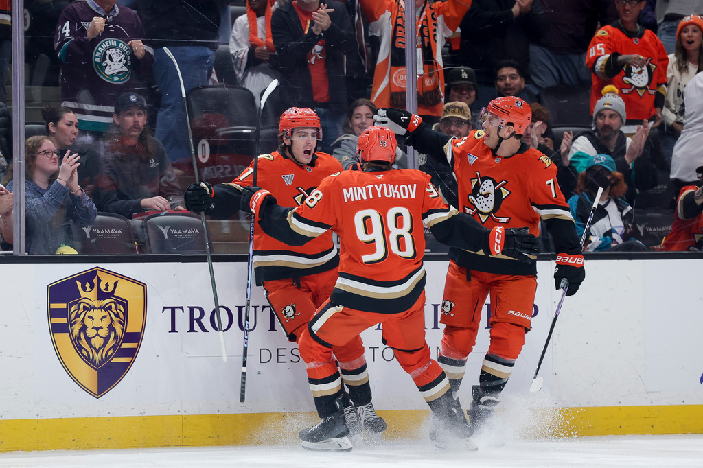 Anaheim Ducks center Leo Carlsson, left, celebrates with defenseman Pavel Mintyukov, center, and defenseman John Carlson after scoring during the first period of an NHL hockey game against the San Jose Sharks Thursday, April 9, 2026 in Anaheim, Calif. (AP Photo/Ryan Sun)