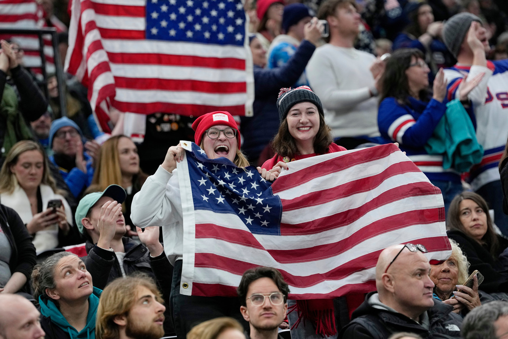 US supporters cheer during a preliminary round match of women's ice hockey between USA and Canada at the 2026 Winter Olympics, in Milan, Italy, Tuesday, Feb. 10, 2026. (AP Photo/Petr David Josek)
