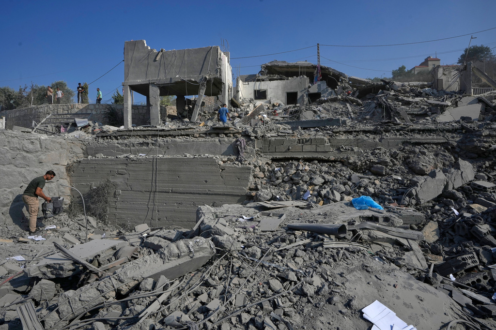 People check a destroyed home that was hit by an Israeli airstrike in Ansar village, southern Lebanon, Saturday, Aug. 15, 2026. (AP Photo/Mohammed Zaatari)