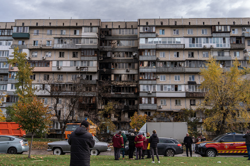 People look at a damaged apartment building following a Russian attack, Sunday, Oct. 26, 2025, in Kyiv, Ukraine. (AP Photo/Julia Demaree Nikhinson) People look at a damaged apartment building following a Russian attack, Sunday, Oct. 26, 2025, in Kyiv, Ukraine. (AP Photo/Julia Demaree Nikhinson)