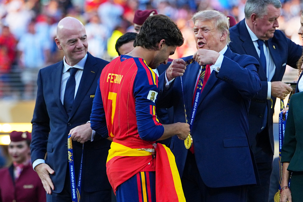 President Donald J. Trump gives Spain's Ferran Torres (7) winners metal during the World Cup final soccer match between Spain and Argentina in East Rutherford, N.J., near New York, Sunday, July 19, 2026. (AP Photo/Julio Cortez)