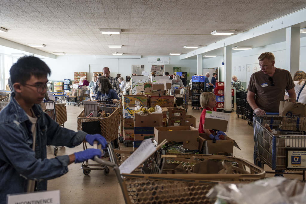 Volunteer shoppers fill grocery orders at the Edmonds Food Bank in Edmonds, Wash., Monday, Sept. 8, 2025. (AP Photo/Annika Hammerschlag)