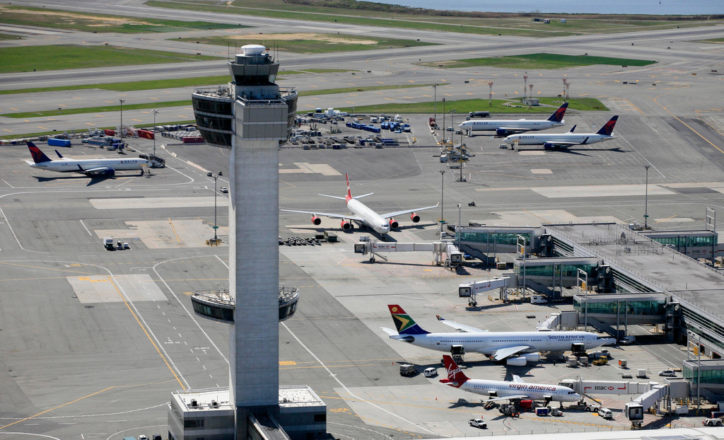 FILE - The air traffic control tower rises above terminals at John F. Kennedy International Airport in New York, April 20, 2010. (AP Photo/Mark Lennihan, File)