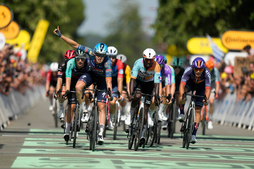 Belgium's Tim Merlier celebrates as he crosses the finish line to win the eighth stage of the Tour de France cycling race with start in Perigueux and finish in Bergerac, France, Saturday, July 11, 2026. (AP Photo/Mosa'ab Elshamy)