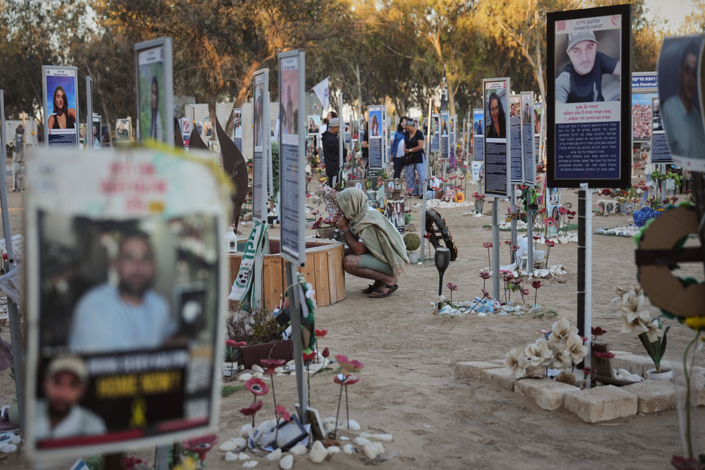 People visit the site of the Nova music festival, where hundreds of revelers were killed and abducted by Hamas and taken into Gaza, as Israel marks the second year anniversary of the attack, near Kibbutz Reim, southern Israel, Tuesday, Oct. 7, 2025. (AP Photo/Ariel Schalit)