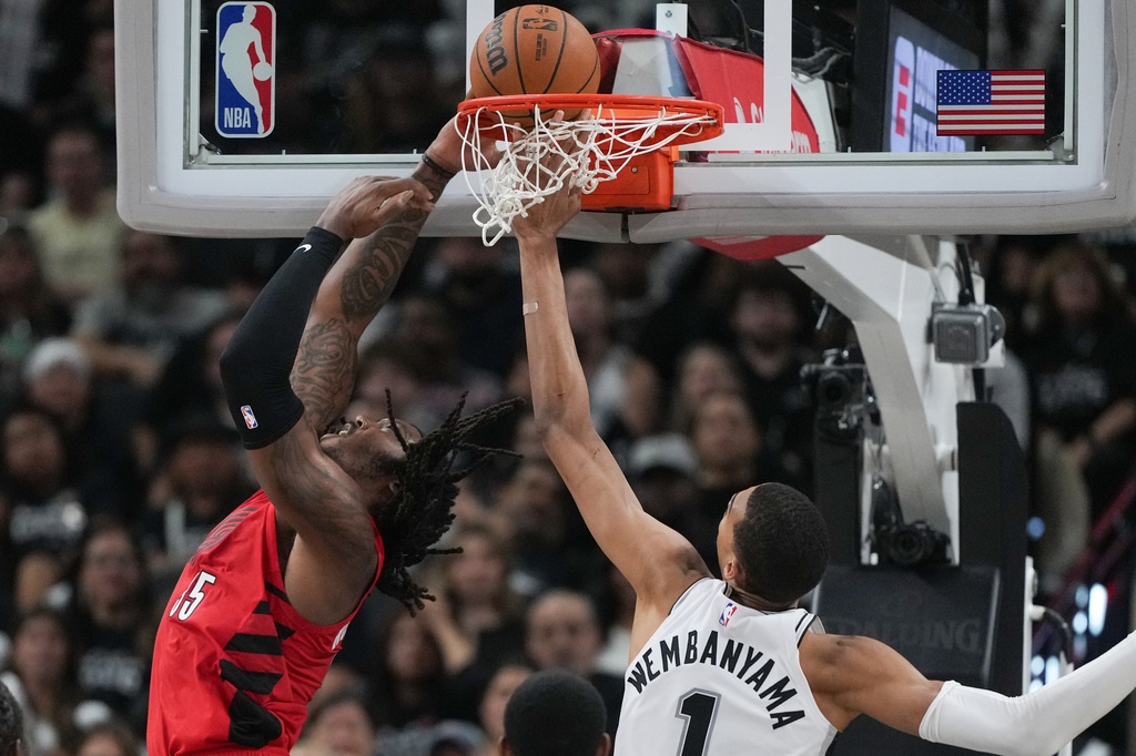 Portland Trail Blazers center/forward Robert Williams III (35) scores past San Antonio Spurs forward/center Victor Wembanyama (1) during the second half in Game 5 of a first-round NBA playoffs basketball series in San Antonio, Tuesday, April 28, 2026. (AP Photo/Eric Gay)