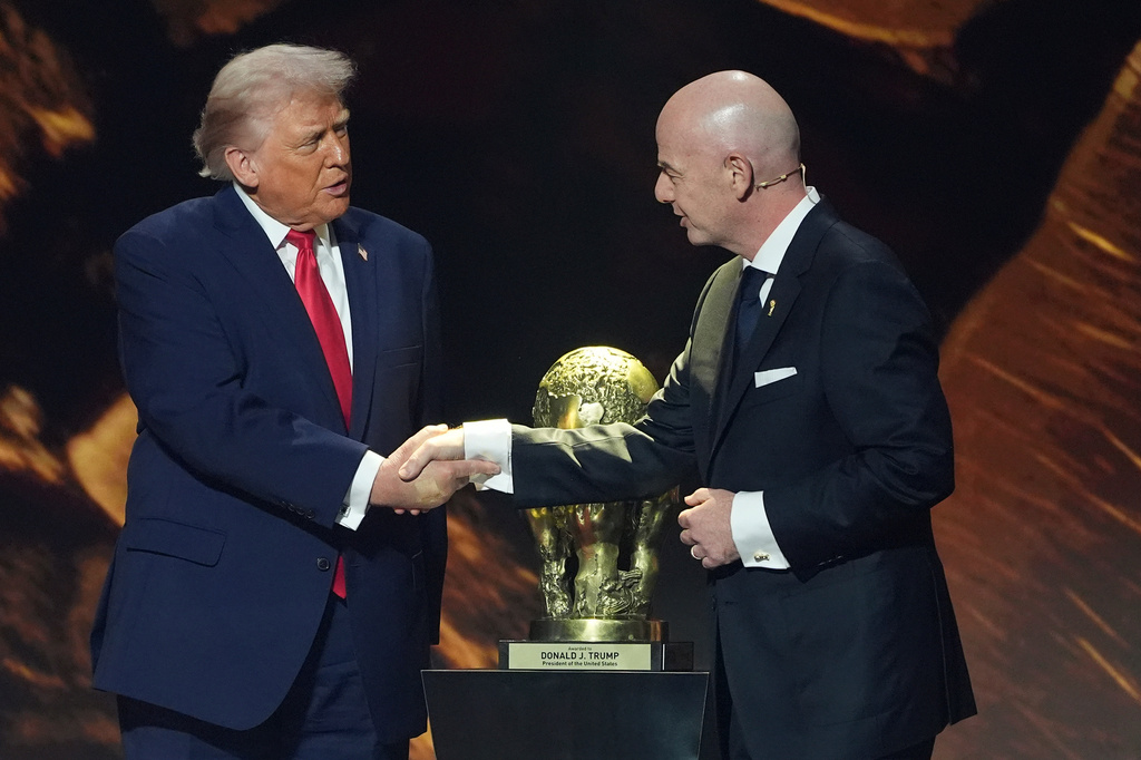 FILE - President Donald Trump shakes hands with FIFA President Gianni Infantino as he presented with the inaugural FIFA Peace Prize during the 2026 FIFA World Cup draw at the Kennedy Center, Dec. 5, 2025, in Washington. (AP Photo/Evan Vucci, File)