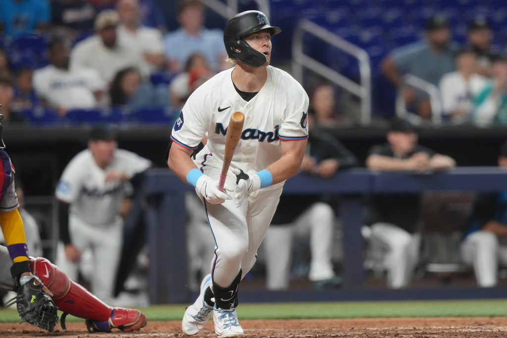 Miami Marlins' Kyle Stowers watches his hit to center field during the sixth inning of a baseball game against the Arizona Diamondbacks Tuesday, June 9, 2026, in Miami. (AP Photo/Marta Lavandier)