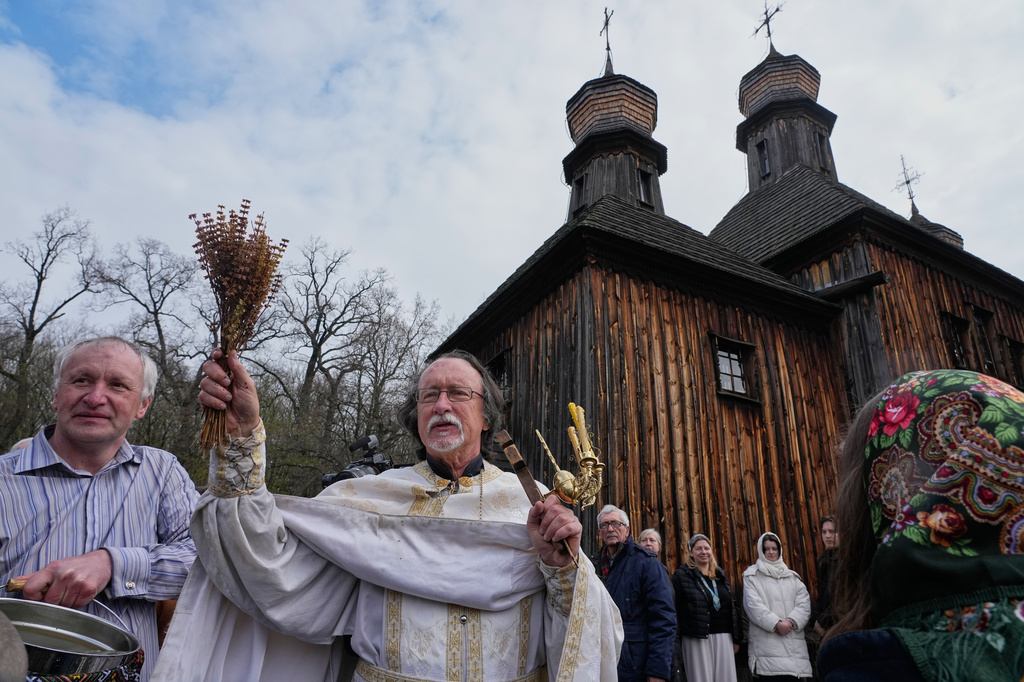 Priests bless believers and their Easter baskets to mark Orthodox Easter, in Pyrohiv, close to Kyiv, Ukraine, Sunday, April 12, 2026. (AP Photo/Efrem Lukatsky)