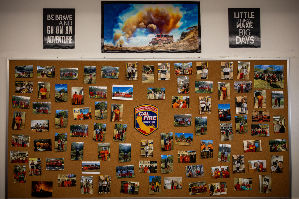 Photos are pinned to a bulletin board at the Pine Grove Youth Conservation Camp, July 14, 2025, in Red Corral, Calif. (AP Photo/Ethan Swope)