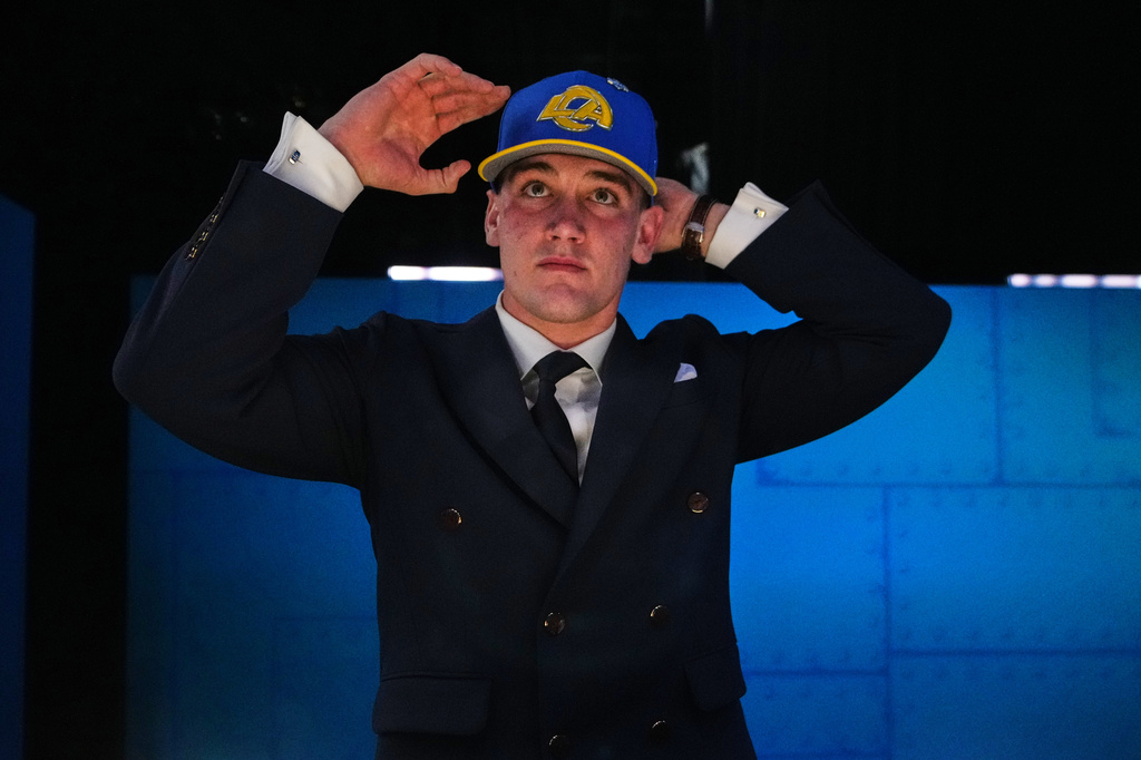 Alabama quarterback Ty Simpson puts on a hat after being chosen by the Los Angeles Rams with the 13th overall pick during the first round of the NFL football draft, Thursday, April 23, 2026, in Pittsburgh. (AP Photo/Jeff Roberson)