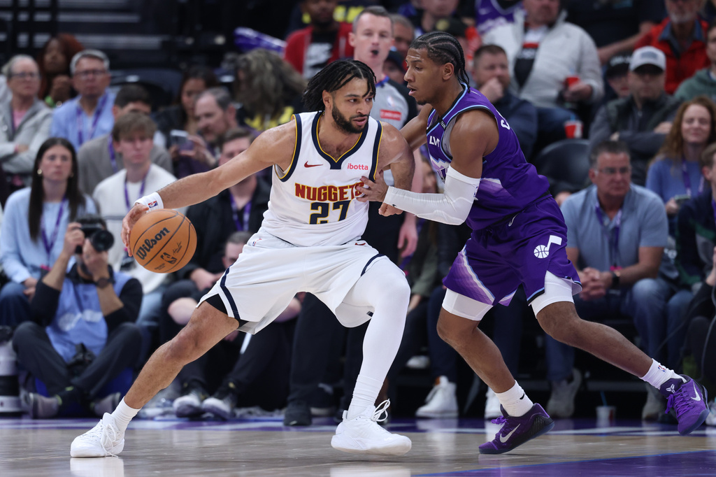 Denver Nuggets guard Jamal Murray (27) moves the ball as Utah Jazz guard Kennedy Chandler defends during the first half of an NBA basketball game, Wednesday, April 1, 2026, in Salt Lake City. (AP Photo/Rob Gray)