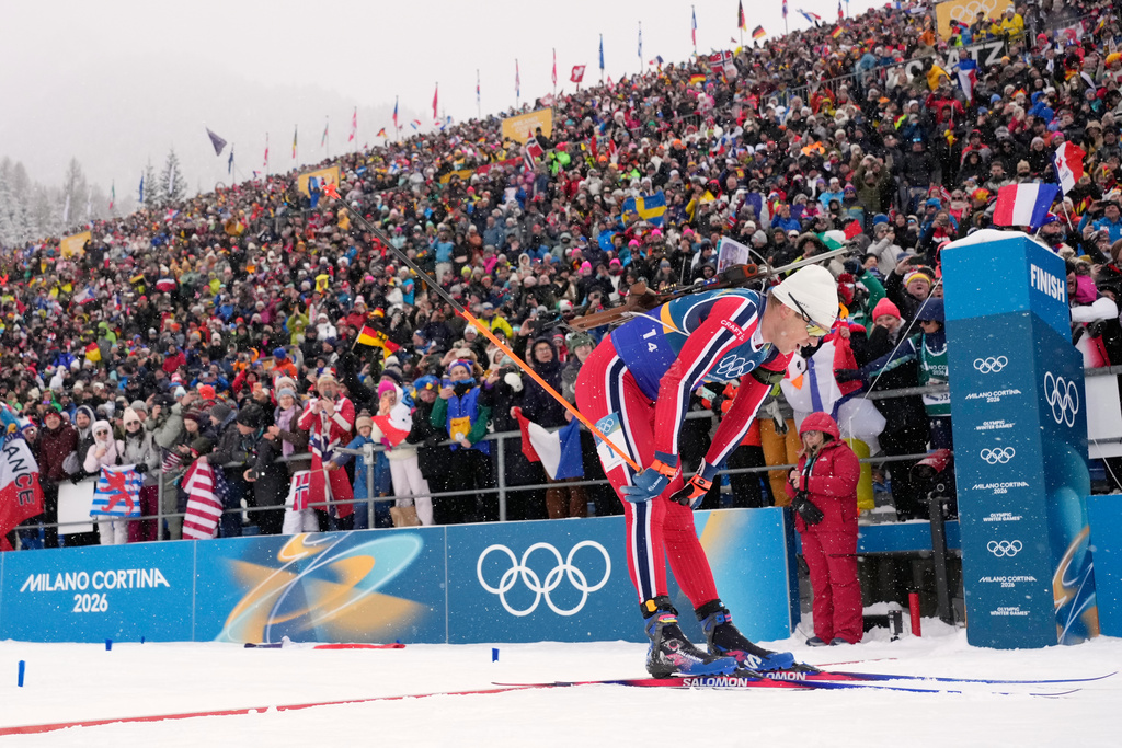 Vetle Sjaastad Christiansen, of Norway, crosses the finish line for silver in the men's 4x7.5-kilometer relay biathlon race at the 2026 Winter Olympics in Anterselva, Italy, Tuesday, Feb. 17, 2026. (AP Photo/David J. Phillip)