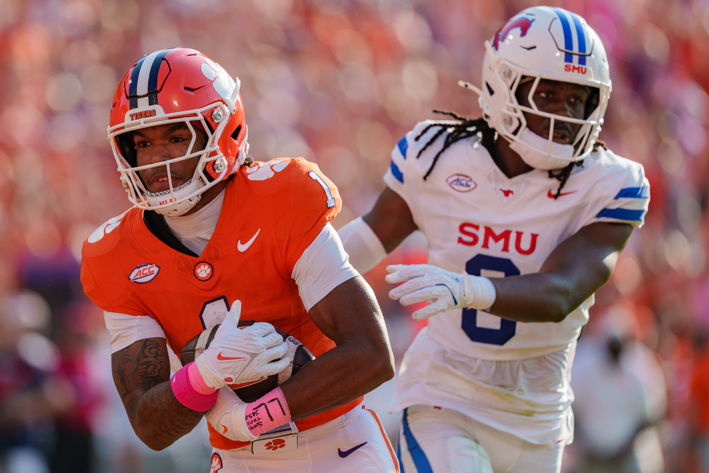 Clemson wide receiver T.J. Moore (1) scores a touchdown while covered by SMU cornerback William Nettles (0) in the first half of an NCAA college football game Saturday, Oct. 18, 2025, in Clemson, S.C. (AP Photo/Jacob Kupferman)