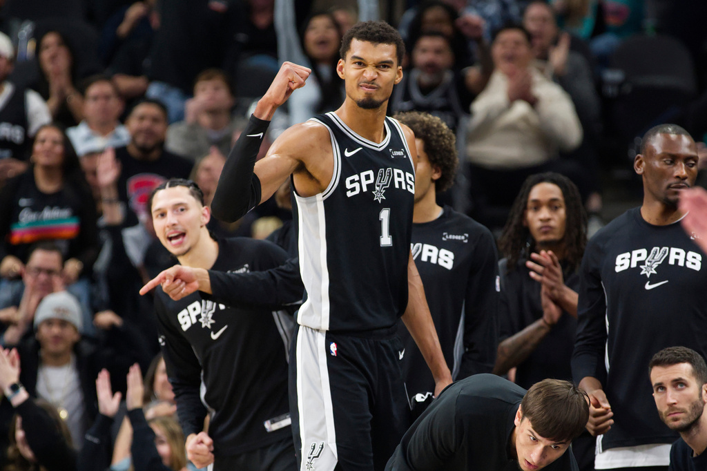 San Antonio Spurs center Victor Wembanyama (1) celebrates a basket during the second half of an NBA basketball game against the New York Knicks, Wednesday, Dec. 31, 2025, in San Antonio. (AP Photo/Darren Abate)