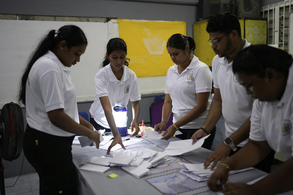 Electoral officials tally ballots after polls closed in Uitvlugt, Guyana, during general elections, Monday, Sept. 1, 2025. (AP Photo/Matias Delacroix)