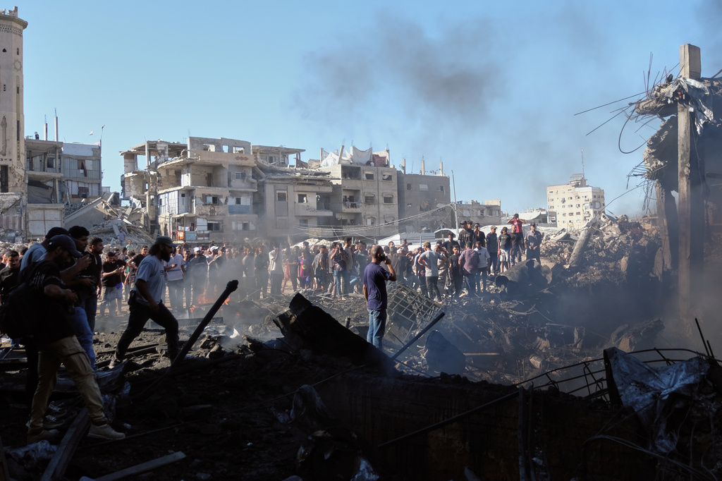 Palestinians inspect the rubble of a building destroyed in an Israeli airstrike in Gaza City, Monday, Aug. 24, 2026. (AP Photo/Jehad Alshrafi)