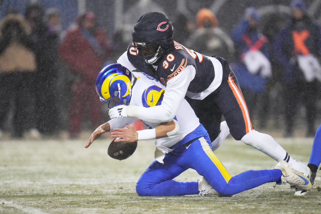 Los Angeles Rams quarterback Matthew Stafford, bottom, recovers his own fumble as he is sacked by Chicago Bears defensive end Dominique Robinson during the second half of an NFL football divisional playoff game Sunday, Jan. 18, 2026, in Chicago. (AP Photo/Erin Hooley)