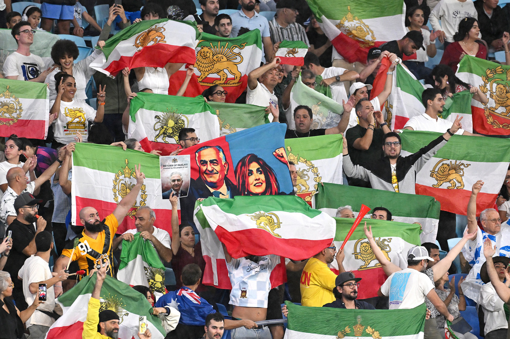 Iran supporters wave flags during the Women's Asian Cup soccer match between Iran and the Philippines in Robina, Australia, Sunday, March 8, 2026. (Dave Hunt/AAPImage via AP)