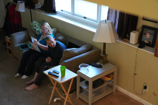 Bill Swick, right, looks around while study with his wife Martha Swick at their home in Minooka, Ill., Friday, Oct. 24, 2025. (AP Photo/Nam Y. Huh) Bill Swick, right, looks around while study with his wife Martha Swick at their home in Minooka, Ill., Friday, Oct. 24, 2025. (AP Photo/Nam Y. Huh)